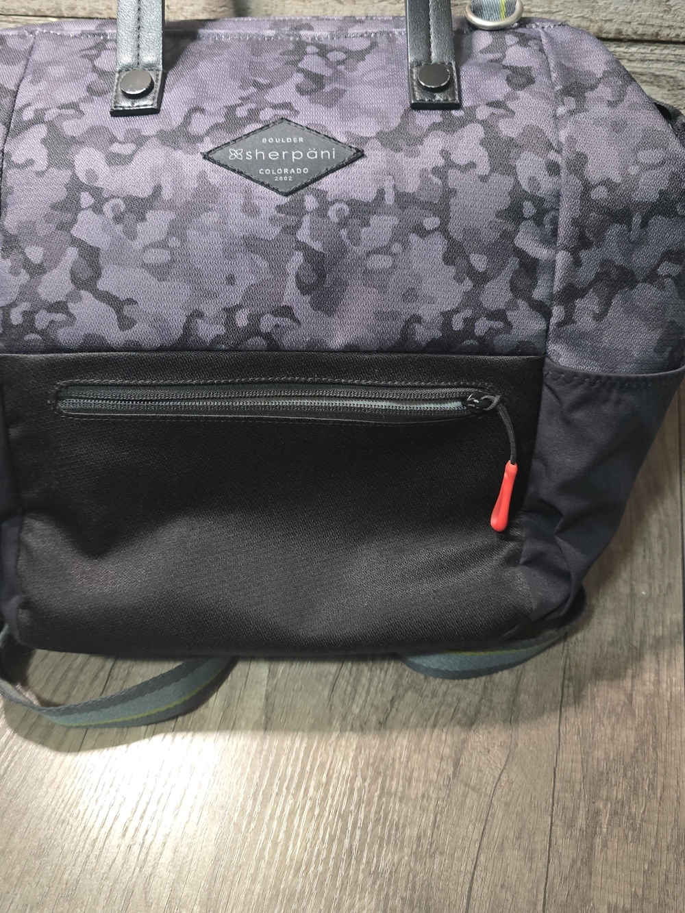 Sherpani convertible bag featuring a grey camouflage pattern.